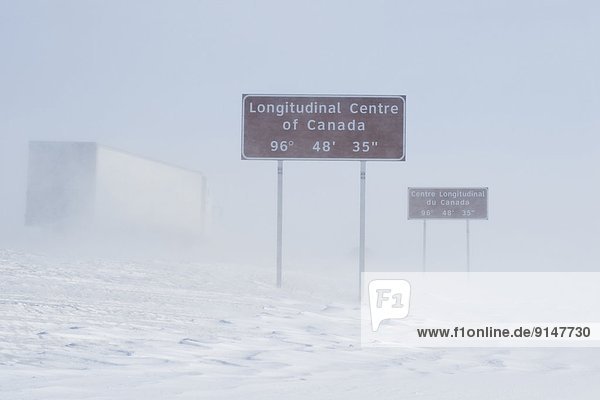 signage along Trans-Canada Highway east of Winnipeg during winter  Manitoba  Canada
