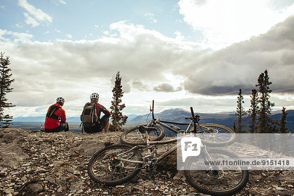 Two mountain bikers enjoying the fall colors and trails in Whitehorse  Yukon