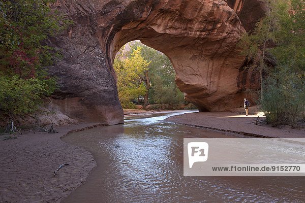 Hiker at Jacob Hamblin Arch in Coyote Gulch  Grandstaircase-Escalante National Monument  Utah  United States