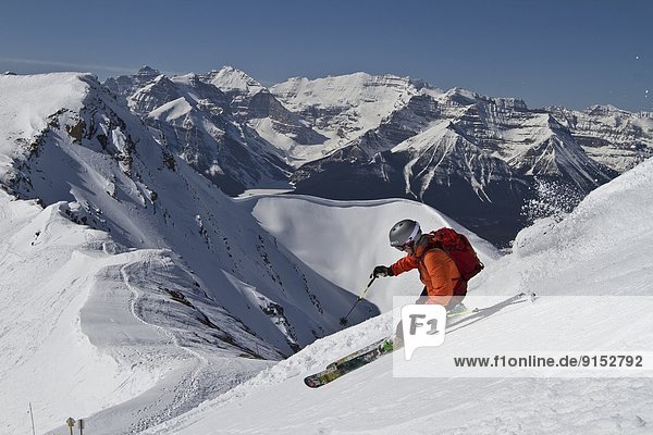 Young male skier skiing untracked slope at Lake Louise Ski Resort  Alberta  Canada.  Alberta  Canada.