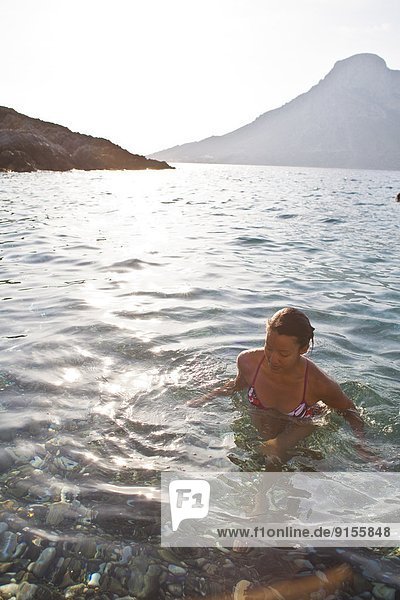 a young woman going for a quick swim after a day of rockclimbing - while on a climbing trip to Kalymnos  Greece