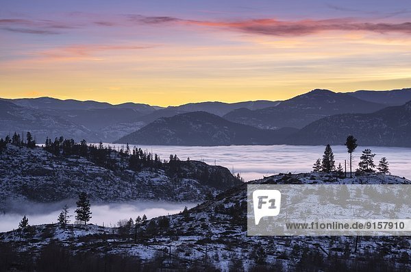 The town of Penticton covered with fog after sunset. British Columbia  Canada.
