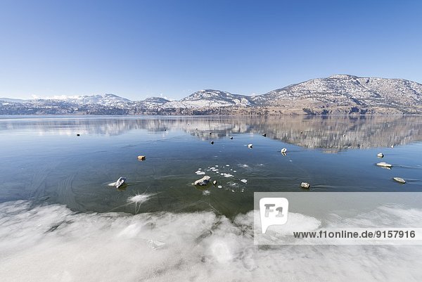 Skaha Lake covered with ice in winter between Penticton and Okanagan Falls  British Columbia  Canada