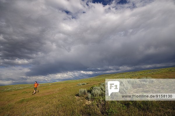 Man trail running near Ten Sleep  Wyoming. USA