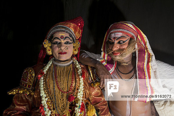Two Katakali artists with the complete make up of the characters Sathi  left  and Old Brahmin  right  for the Dhecheyagam play  Varkala  Kerala  India