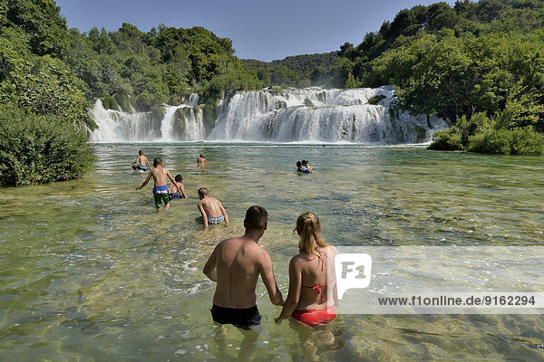 Tourists taking a bath at the Skradinski buk waterfalls  Krka National Park  ?ibenik-Knin County  Dalmatia  Croatia