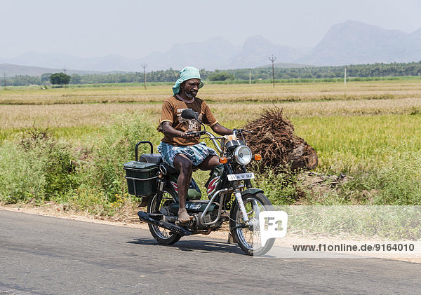 Indian man driving a motorcycle  Uttamapalaiyam  Tamil Nadu  India