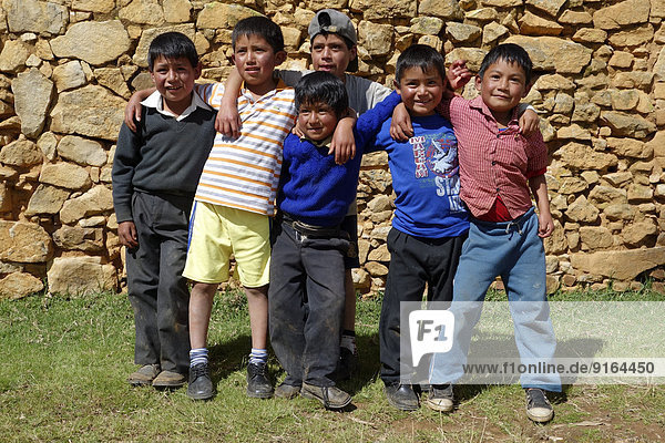 Group of children standing in front of the ruins of Viracochapampa near Huamancuco  Peru