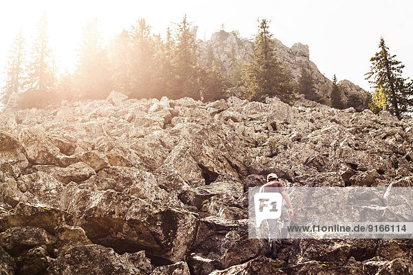 Man climbing rocky hillside
