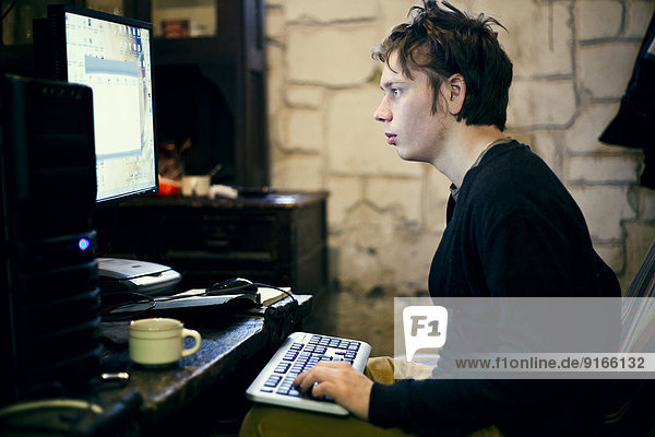 Caucasian man using computer at desk