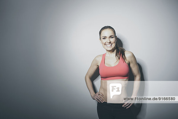 Portrait of smiling Caucasian woman in sports-bra