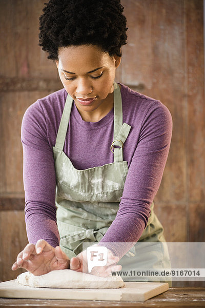 Black woman kneading dough