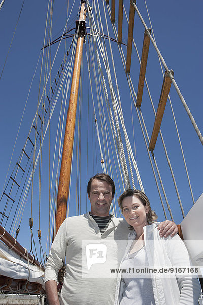 Caucasian couple smiling on sailboat