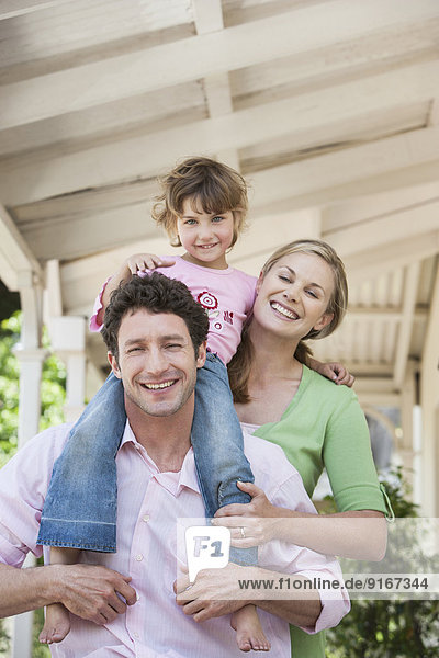 Caucasian family smiling on porch