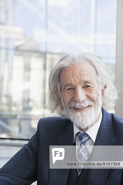 Senior Caucasian businessman smiling in office