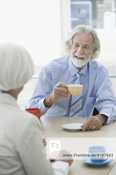 Senior Caucasian couple having coffee in cafe