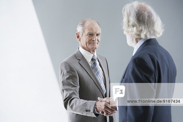 Senior Caucasian businessmen shaking hands