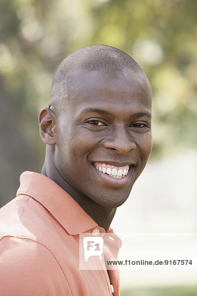 Black man smiling outdoors