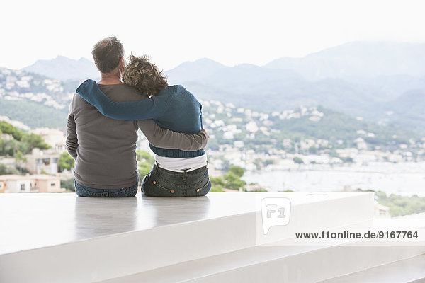 Couple admiring view from balcony