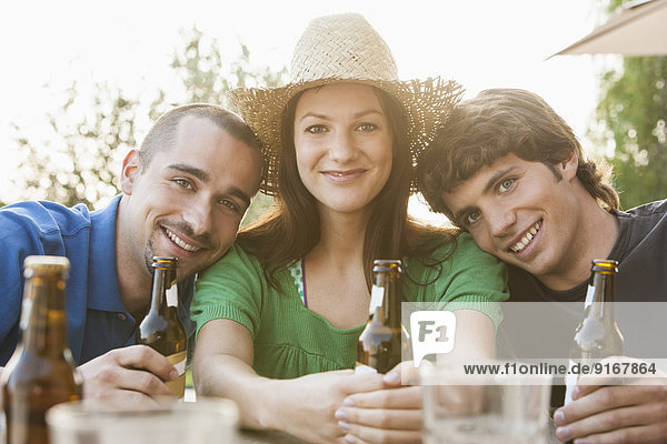 Friends drinking beer together outdoors