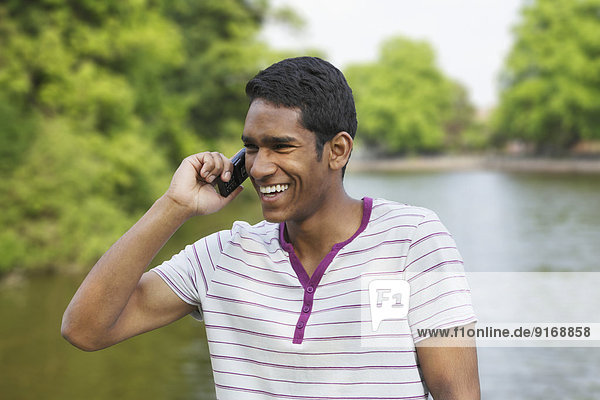Sri Lankan man talking on cell phone outdoors