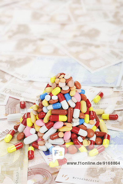 Pile of prescription pills on Euro notes