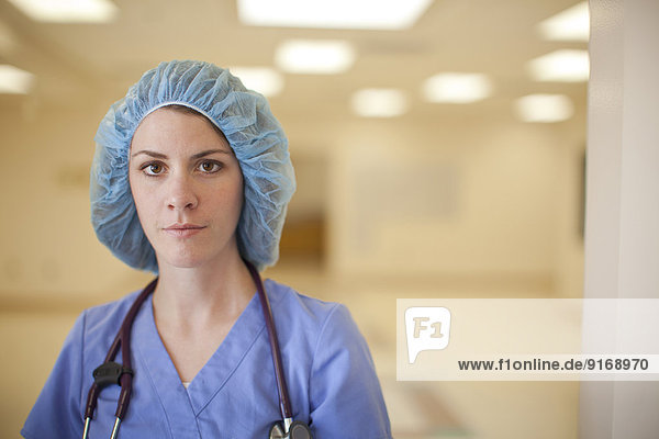 Caucasian nurse wearing hair net in hospital