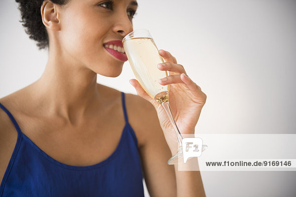 Black woman drinking champagne