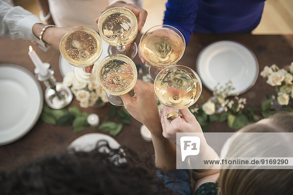 Women toasting each other with champagne