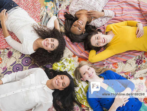 Women relaxing together on blankets