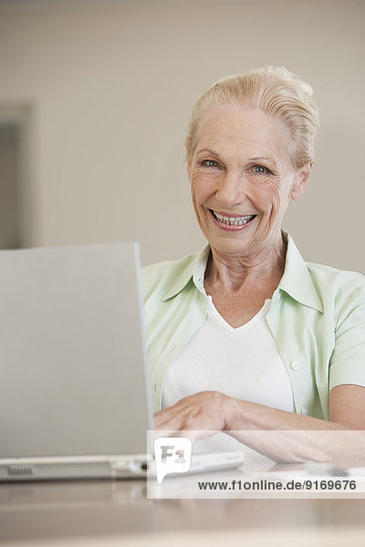 Senior Caucasian woman using laptop