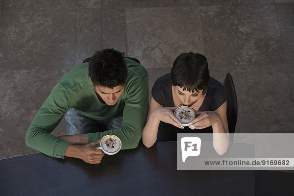 Caucasian couple drinking coffee together