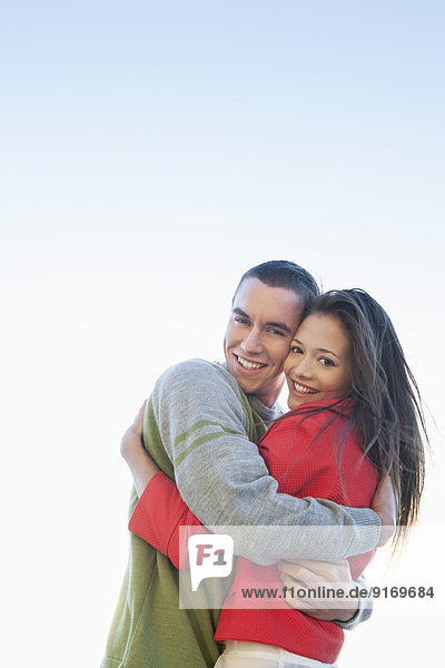 Caucasian couple hugging outdoors