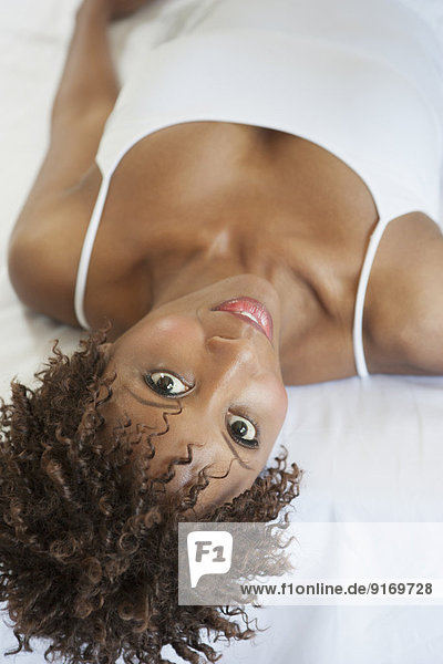 African American woman laying on bed