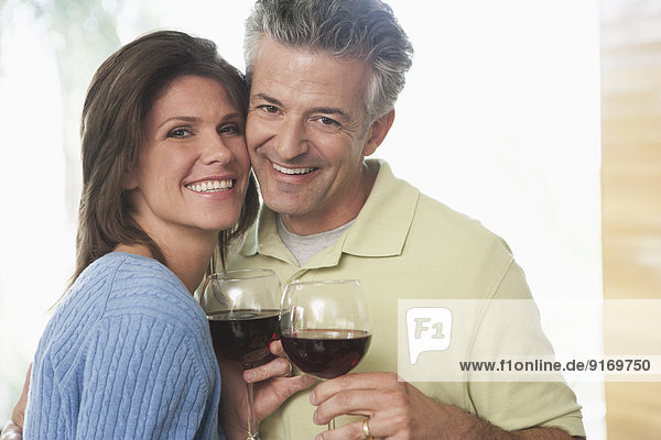Hispanic couple having wine together