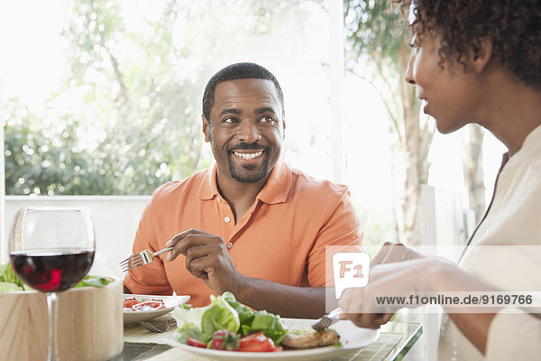 African American couple eating together