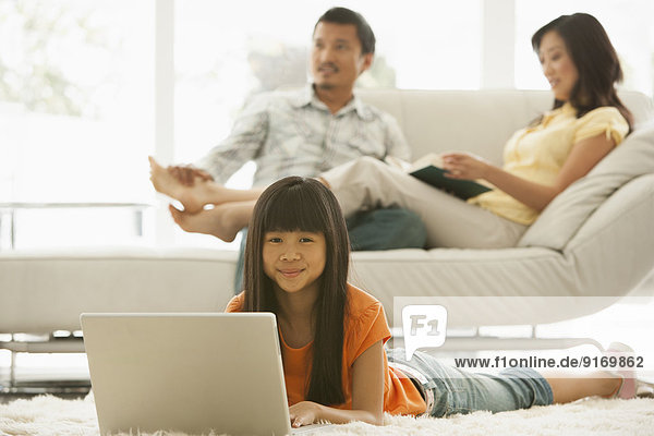 Girl using laptop in living room