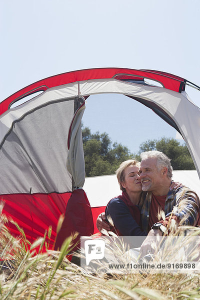 Senior Caucasian couple relaxing at campsite