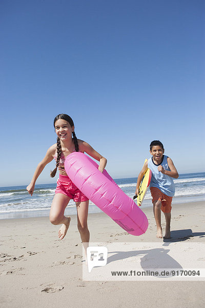 Hispanic children playing on beach