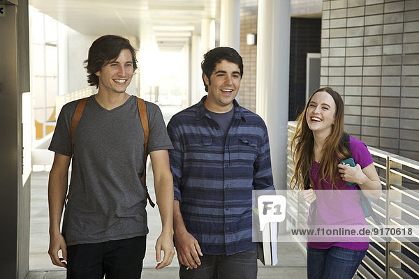 College students laughing in corridor