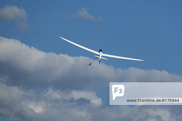 Glider at start in front of clouds