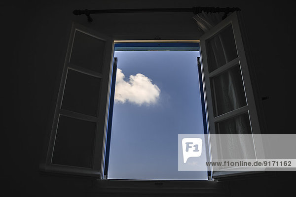 Greece  Cyclades  Naxos  View through an open window  Blue sky and cloud