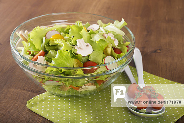 Gemischter Salat in Glasschale mit Champignons,  Radieschen,  Tomaten und Blattsalat
