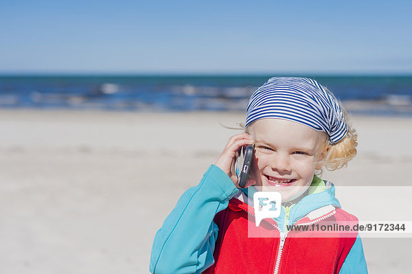 Germany  Mecklenburg-Western Pomerania  Ruegen  Schaabe  Boy on cell phone at the beach