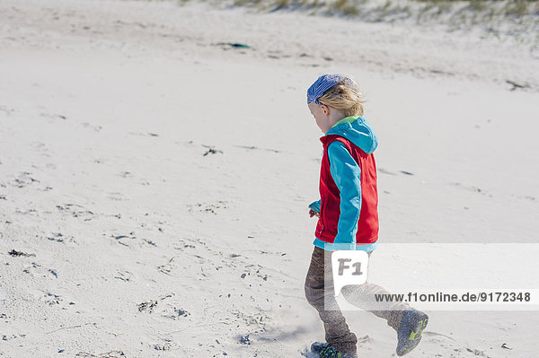 Germany,  Mecklenburg-Western Pomerania,  Ruegen,  Schaabe,  Boy walking on windy beach