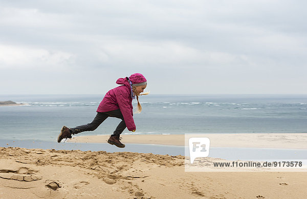 France  Aquitaine  Gironde  Pyla sur Mer  Dune du Pilat  jumping girl on sand dune