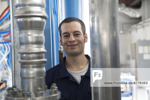 Portrait of smiling technician in a factory building