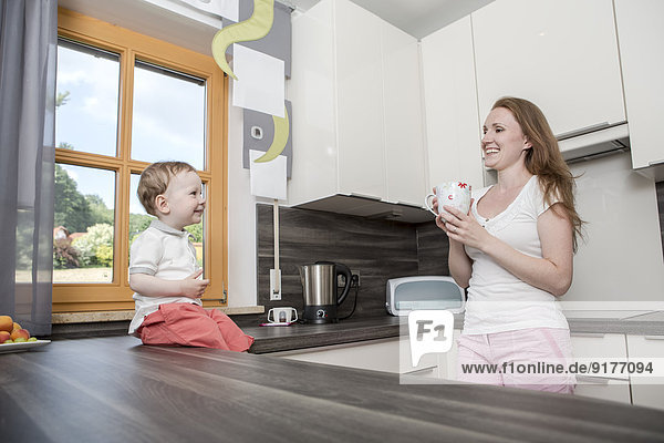 Mother with baby boy in kitchen