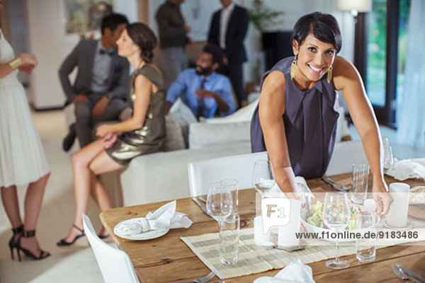 Woman serving food at dinner party