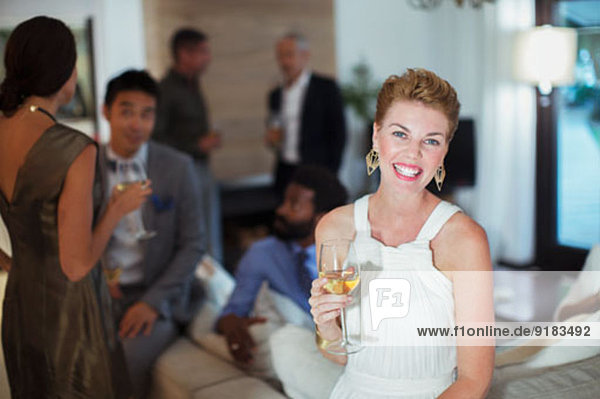 Woman smiling on sofa at party